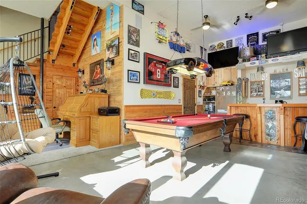 a living room with patio furniture and a flat screen tv