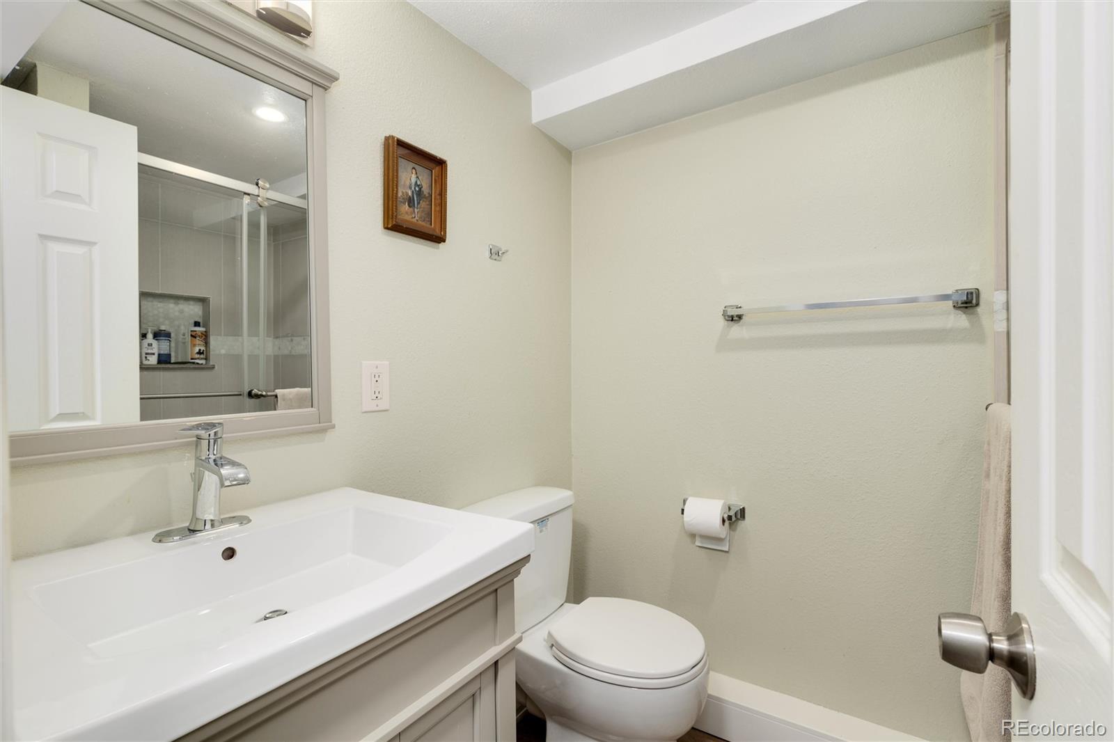 549 Logan Street Denver, CO 80203 - Photo 12 of 14 a bathroom with a sink a toilet and shower