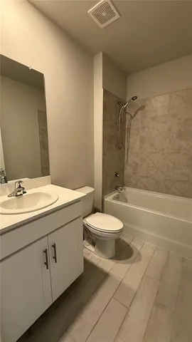 a bathroom with a double vanity sink toilet and shower