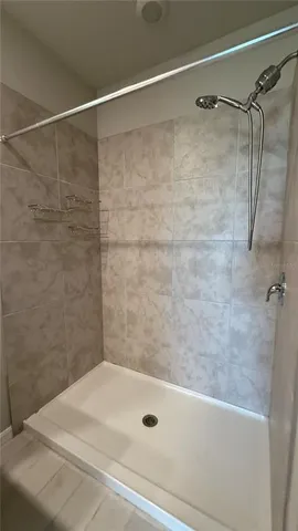 a bathroom with a bathtub and a shower
