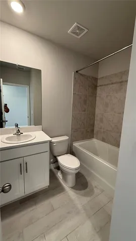 a bathroom with a sink a toilet and a bathtub