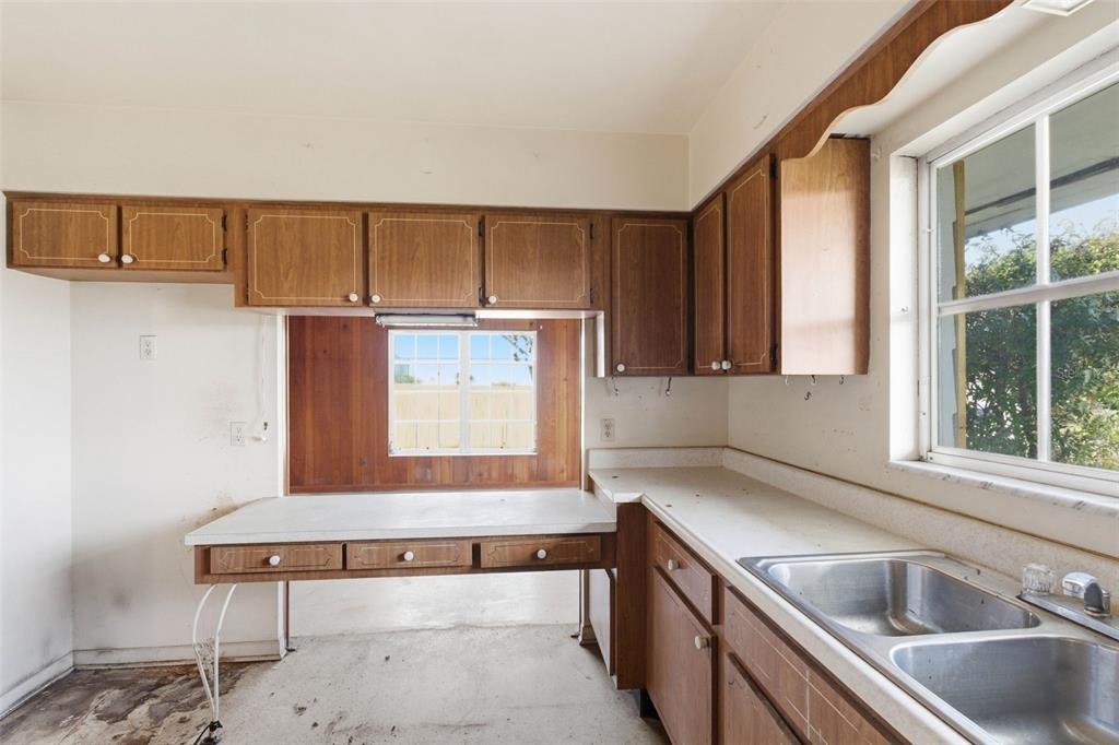 2310 Harrison Drive Dunedin, FL 34698 - Photo 14 of 42 a kitchen with a sink cabinets and window
