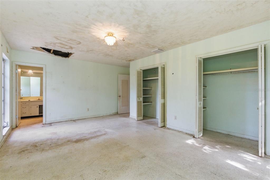 2310 Harrison Drive Dunedin, FL 34698 - Photo 27 of 42 an empty room with closet and a chandelier fan