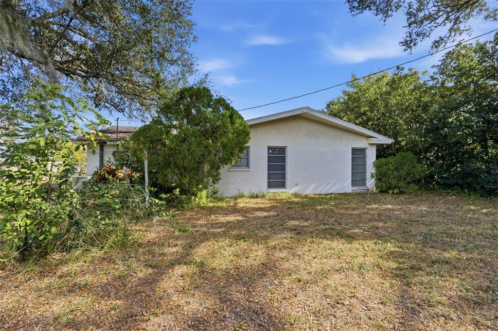 2310 Harrison Drive Dunedin, FL 34698 - Photo 6 of 42 a house with trees in front of it