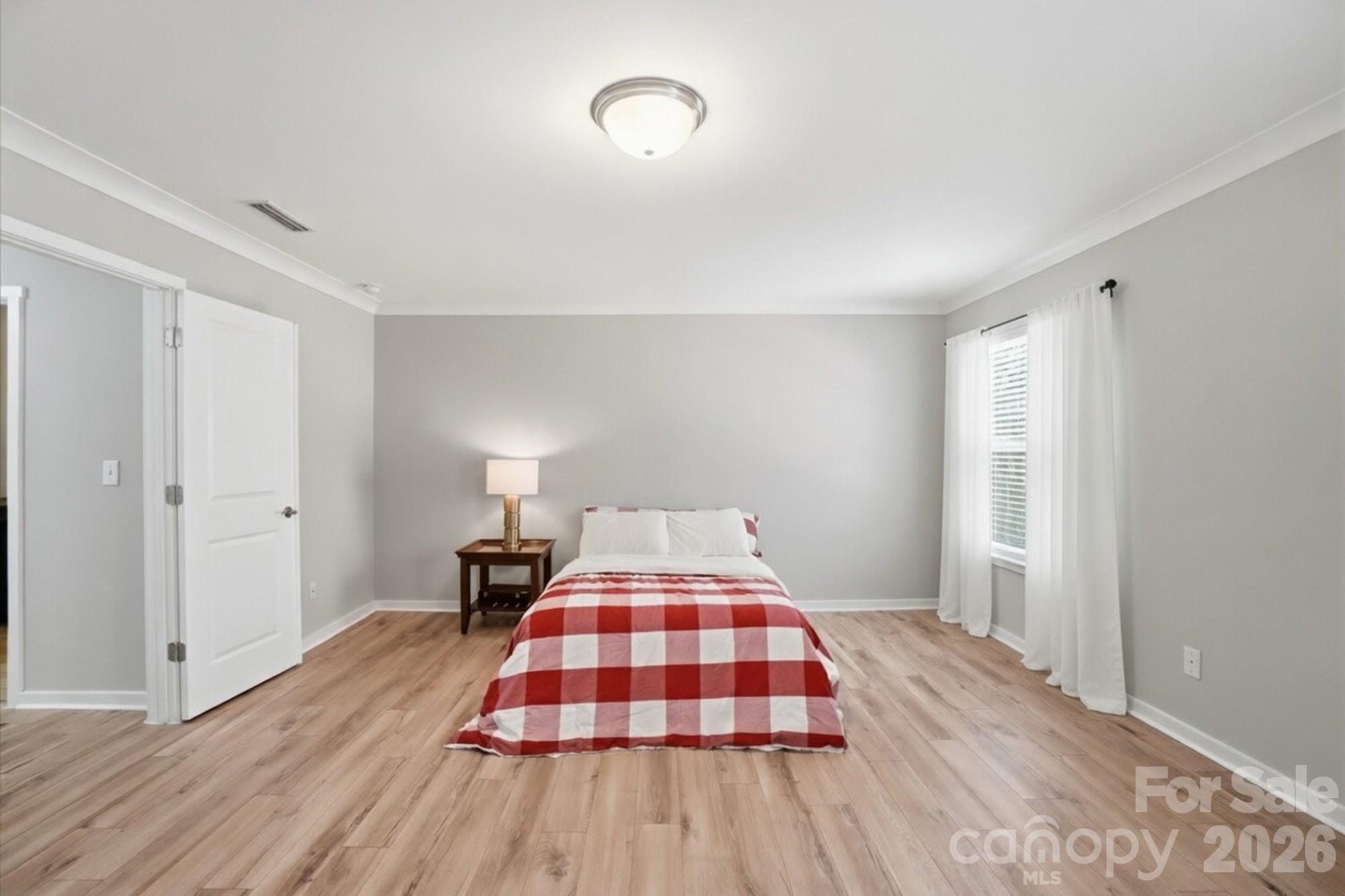 2153 Bluebell Way Tega Cay, SC 29708 - Photo 30 of 48 a bedroom with a bed and wooden floor