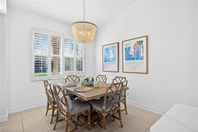 a view of a dining room with furniture wooden floor and chandelier