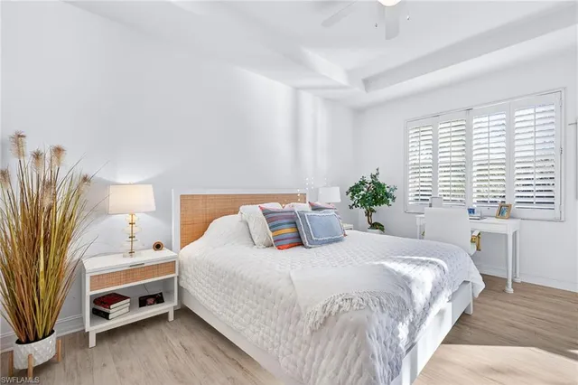 a bedroom with a bed and a potted plant