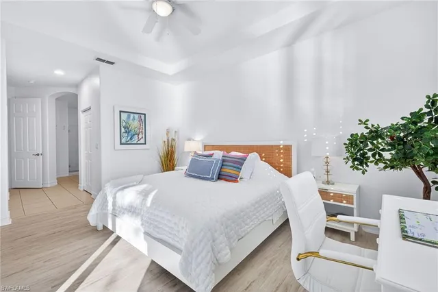a bedroom with a bed and a potted plant