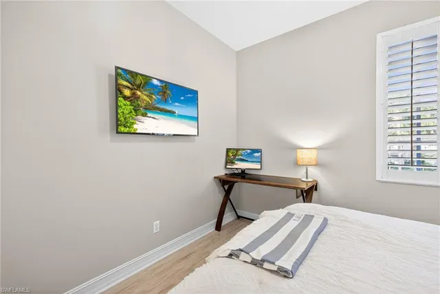 a view of a bedroom with a bed and a window