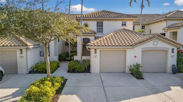 a front view of a house with plants