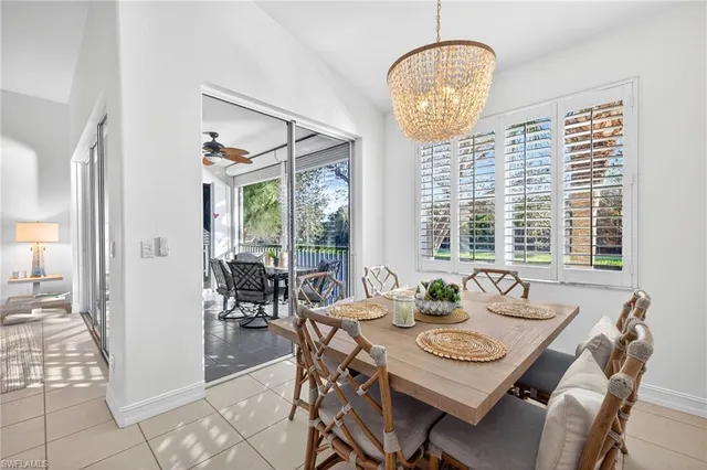 a view of a dining room with furniture large windows and wooden floor
