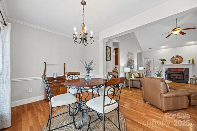a view of a dining room with furniture wooden floor and chandelier