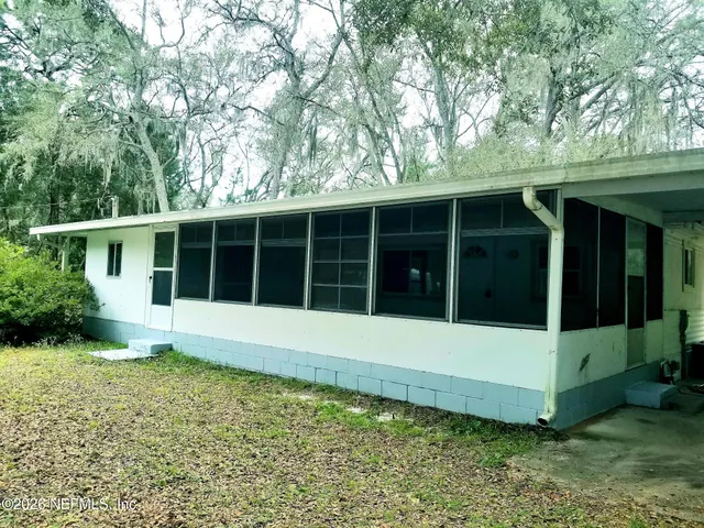 a view of a large window in a yard with large trees