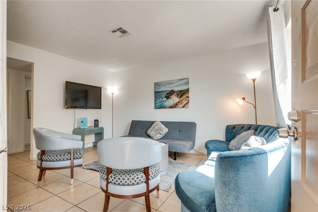 Tiled flooring and neutral walls define this comfortable living space.