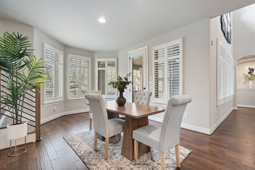 4229 Borho Ranch Street Leander, TX 78641 - Photo 12 of 40 Dining room featuring dark wood-style flooring and baseboards