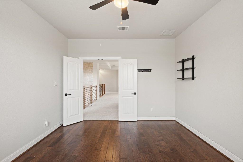 4229 Borho Ranch Street Leander, TX 78641 - Photo 20 of 40 Spare room with dark wood finished floors and a ceiling fan