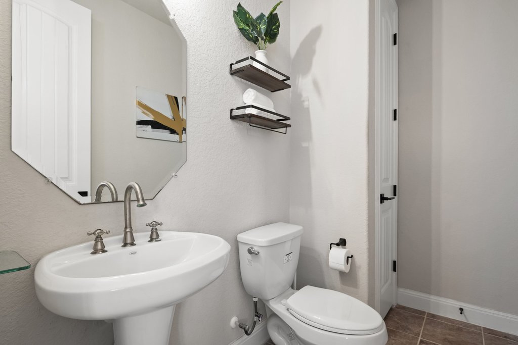 4229 Borho Ranch Street Leander, TX 78641 - Photo 22 of 40 Half bathroom featuring toilet and tile patterned floors