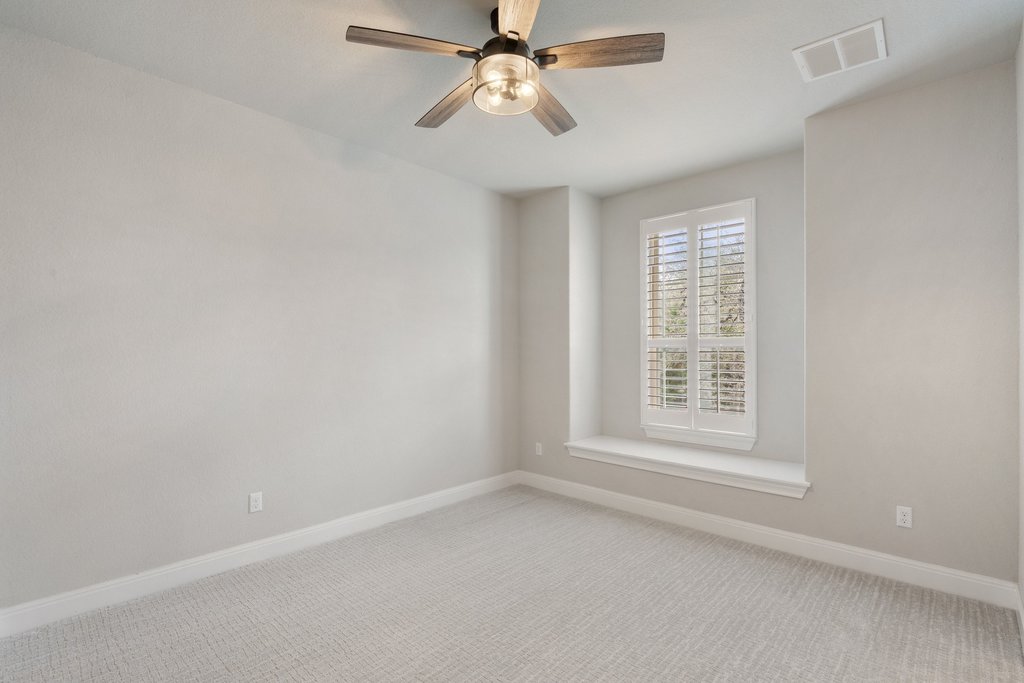 4229 Borho Ranch Street Leander, TX 78641 - Photo 27 of 40 Spare room with light carpet and a ceiling fan