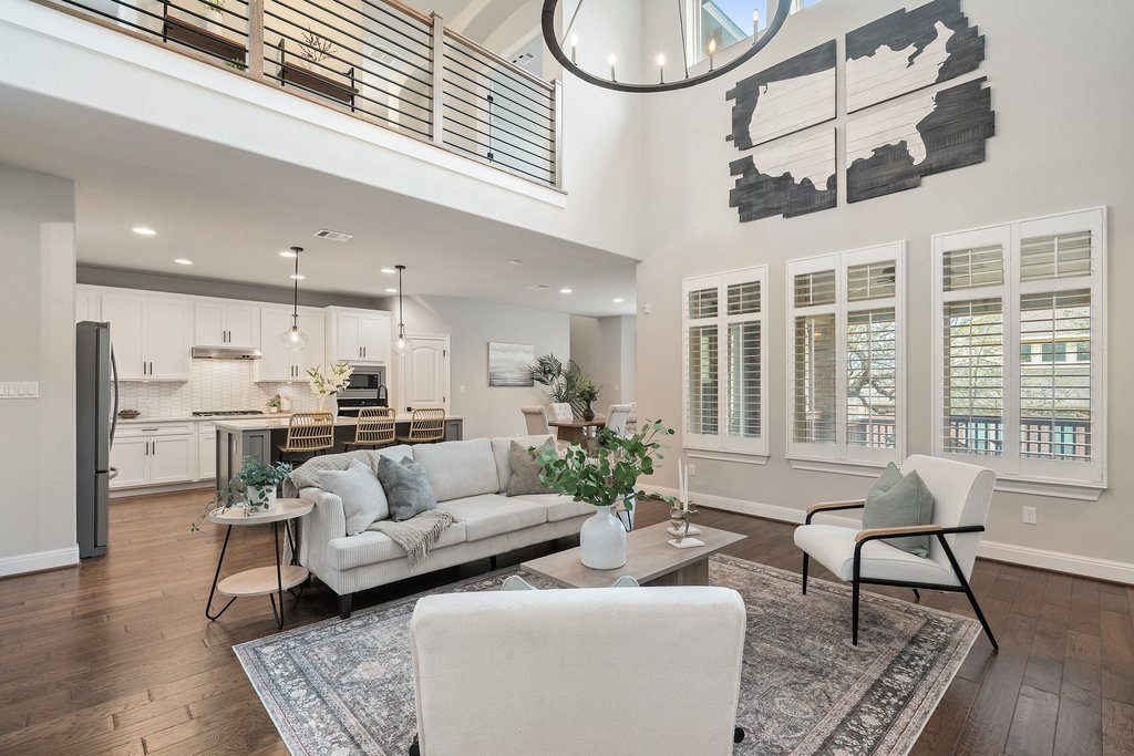 4229 Borho Ranch Street Leander, TX 78641 - Photo 4 of 40 Living room with dark wood finished floors, plenty of natural light, a chandelier, and a high ceiling