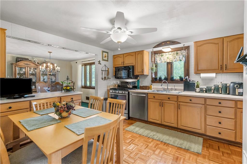 1031 Fiddleback Drive McKees Rocks, PA 15136 - Photo 8 of 20 a large kitchen with a table chairs and flat screen tv