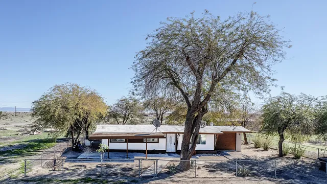 a view of a house with a tree