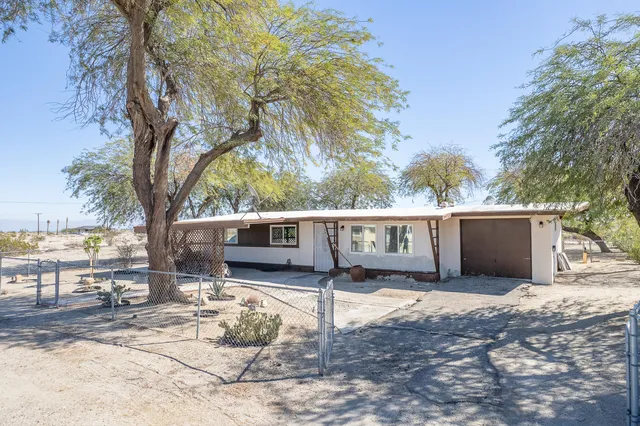 a view of a house with a yard covered in snow
