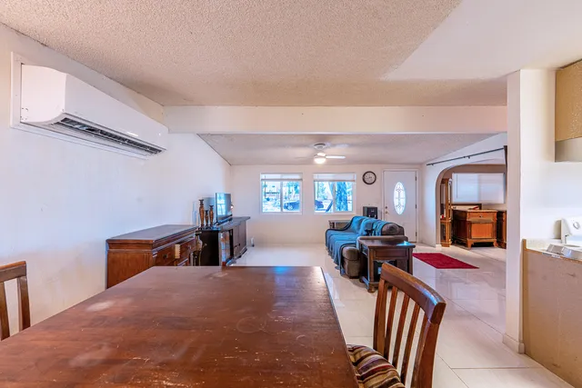 a view of a hallway with wooden floor and windows