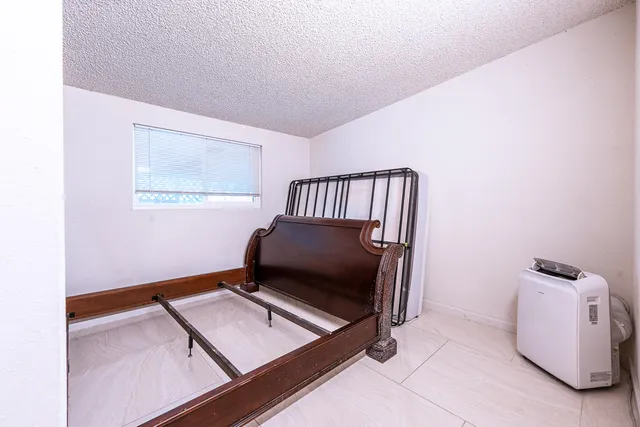 a view of a hallway with wooden floor and closet