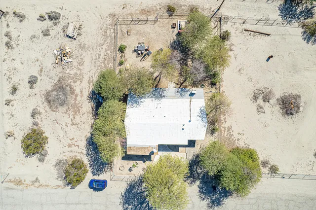 a view of a house with a yard and tree