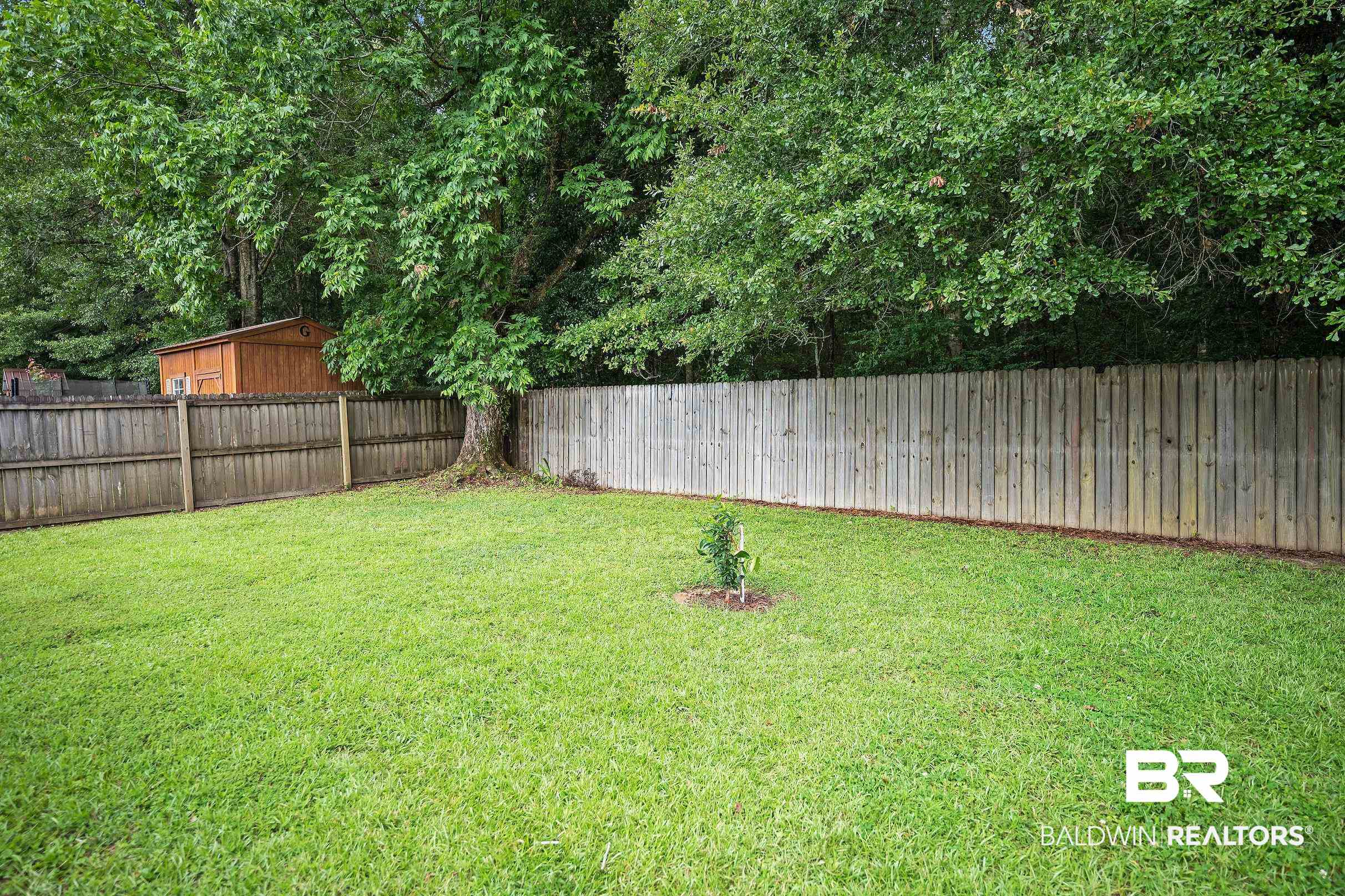 313 Pecan Ridge Boulevard Fairhope, AL 36532 - Photo 34 of 51 Expansive lawn with mature trees and a wood privacy fence