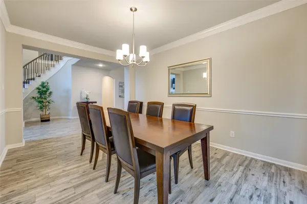 a view of a dining room with furniture wooden floor and chandelier
