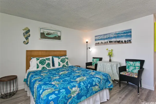 a bedroom with a bed table and chair