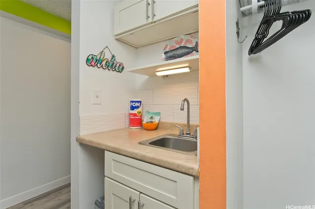 a utility room with sink dryer and washer