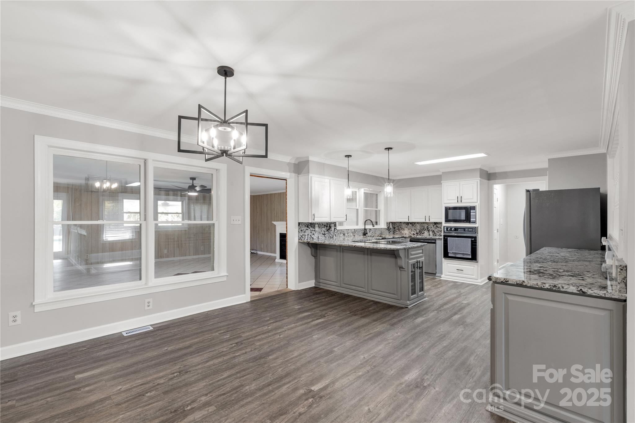 4336 McAllister Road Catawba, SC 29704 - Photo 11 of 47 a large kitchen with kitchen island a large counter space a sink appliances and cabinets