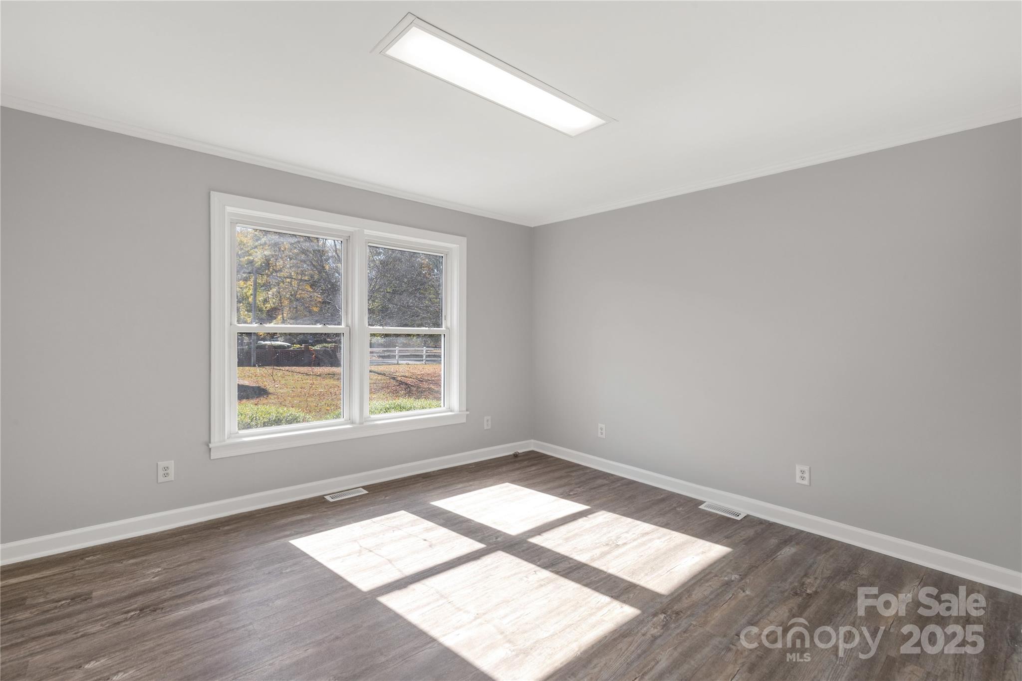 4336 McAllister Road Catawba, SC 29704 - Photo 24 of 47 an empty room with wooden floor and windows
