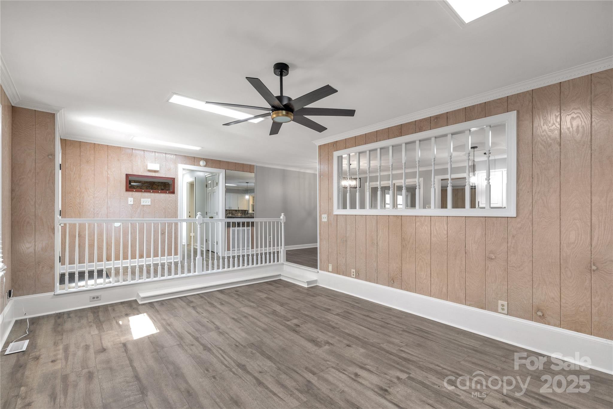 4336 McAllister Road Catawba, SC 29704 - Photo 10 of 47 a view of an empty room with wooden floor and a ceiling fan