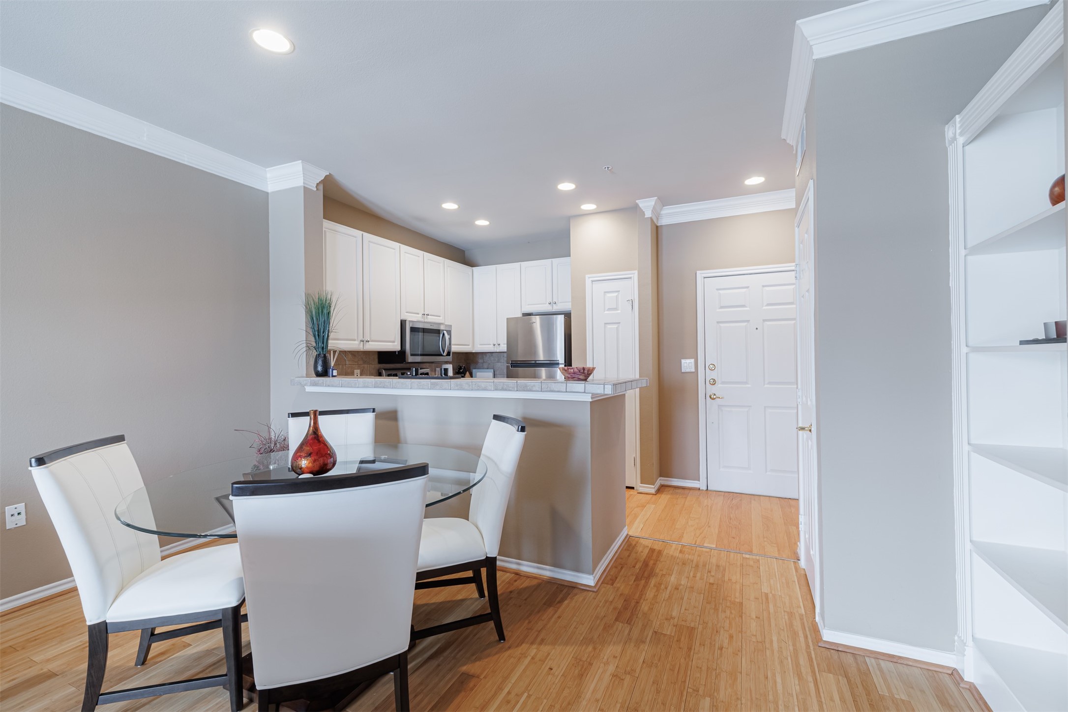 2400 McCue Road, Unit 348 Houston, TX 77056 - Photo 3 of 24 a kitchen with white cabinets and stainless steel appliances