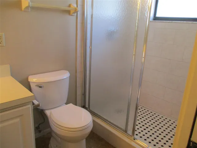 a white toilet sitting next to a shower curtain