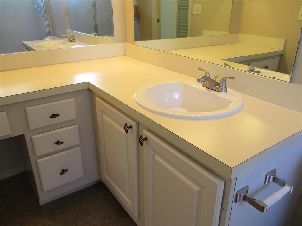 23442 Southwest 57th Avenue, Unit 406 Boca Raton, FL 33428 - Photo 19 of 25 a bathroom with a sink and a mirror