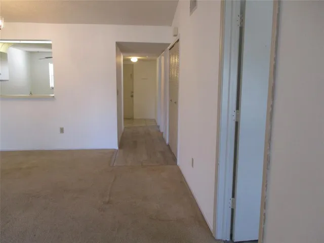 a view of a hallway with closet area