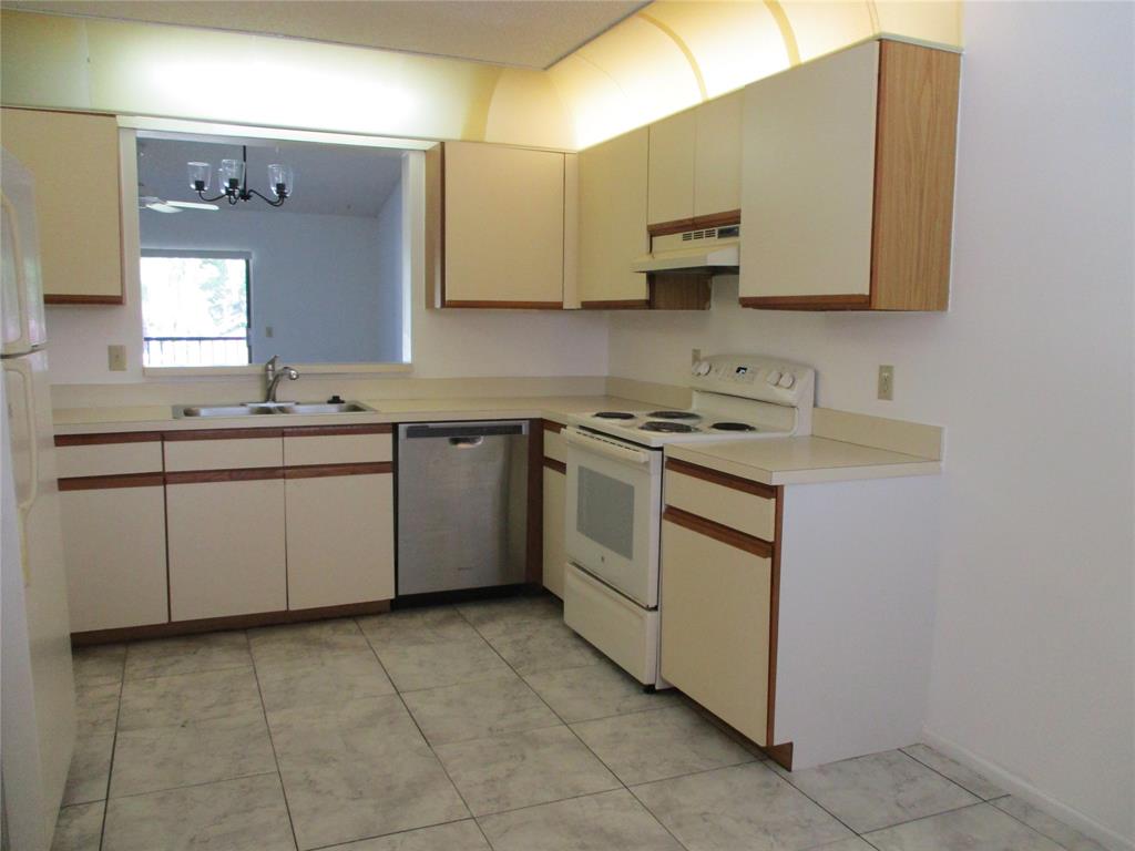 23442 Southwest 57th Avenue, Unit 406 Boca Raton, FL 33428 - Photo 3 of 25 a kitchen with a sink stove and microwave
