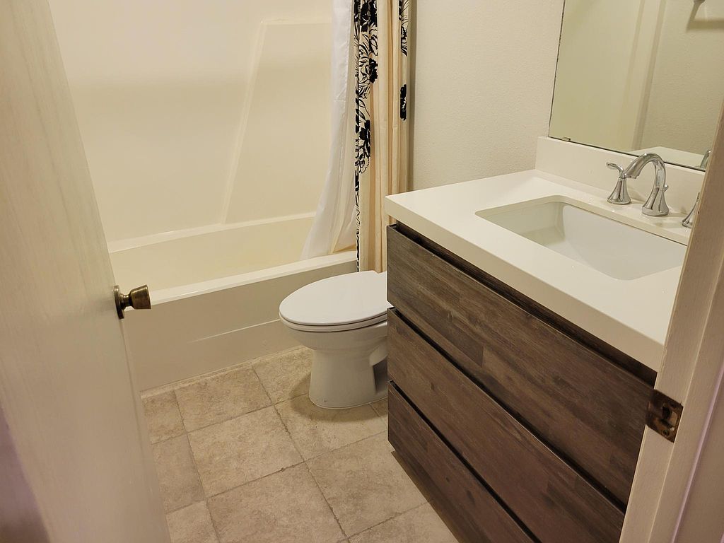 1401 Camp Craft Road, Unit C Austin, TX 78746 - Photo 8 of 12 A well-appointed bathroom with contemporary vanity and neutral tiling provides a refreshing oasis.