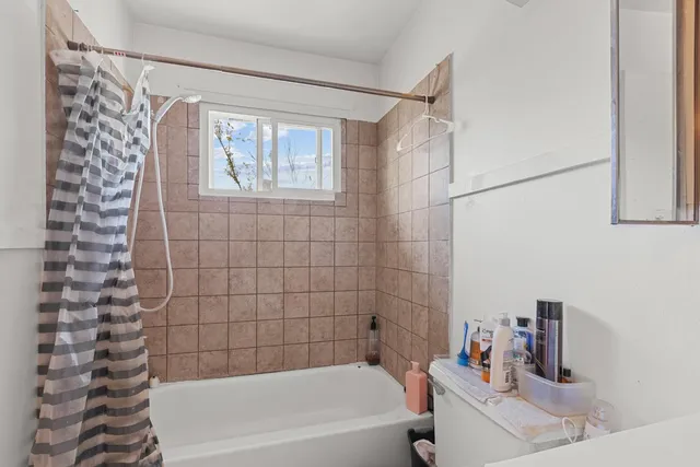 a bathroom with a bathtub and shower