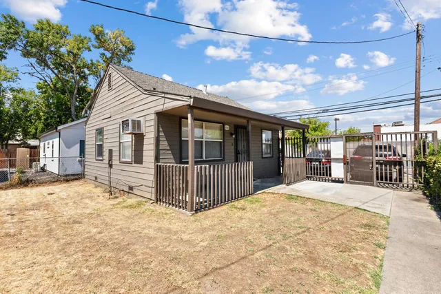 a view of a house with a wooden fence