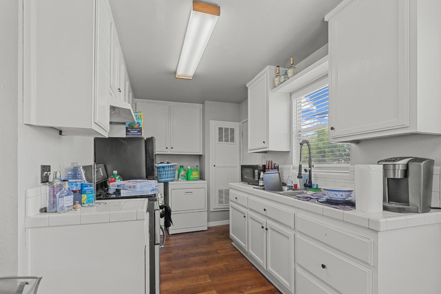 2123 15th Avenue Sacramento, CA 95822 - Photo 27 of 35 a kitchen with cabinets a sink and appliances