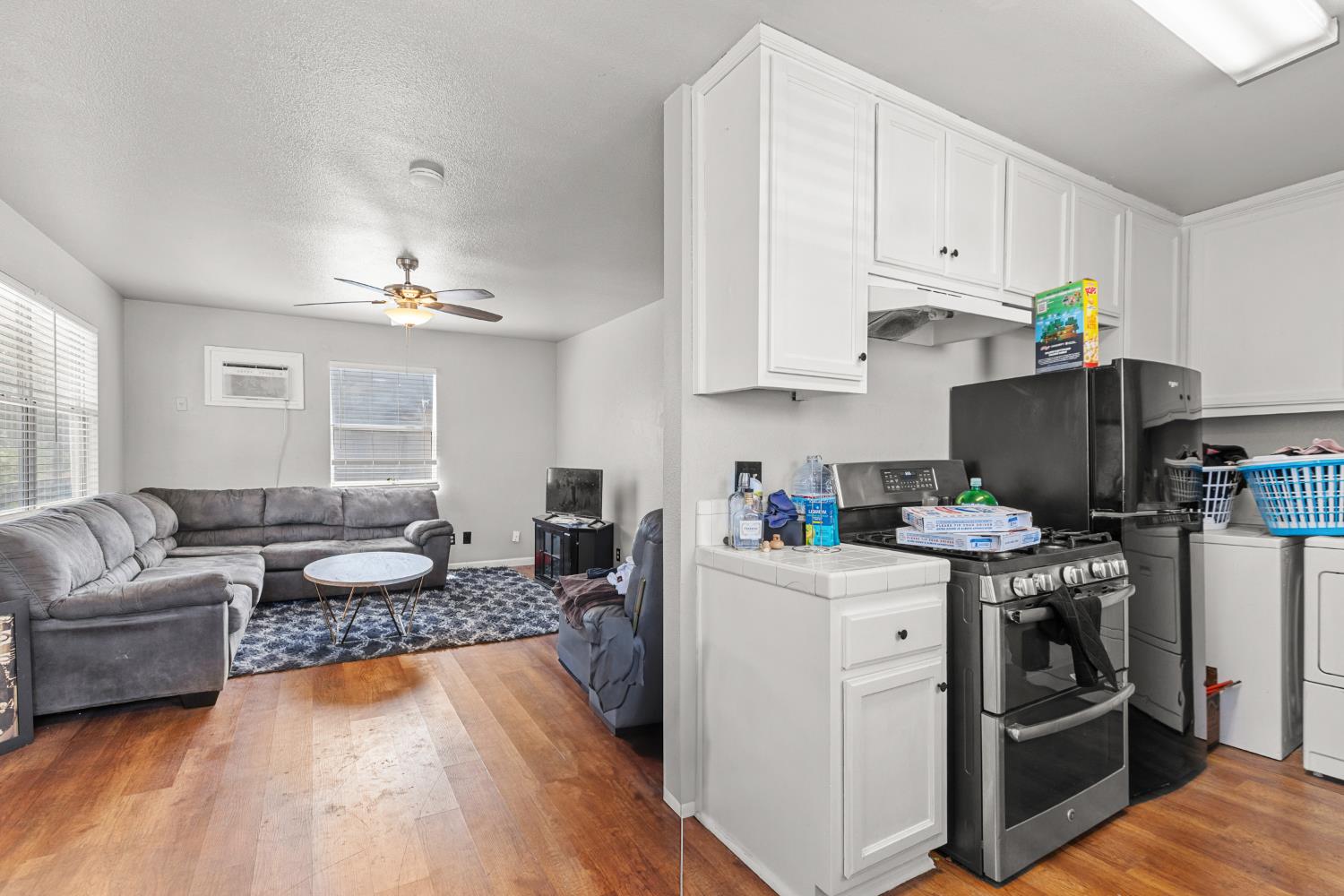 2123 15th Avenue Sacramento, CA 95822 - Photo 28 of 35 a open kitchen with stainless steel appliances granite countertop a stove top oven a refrigerator a sink and dishwasher with white cabinets