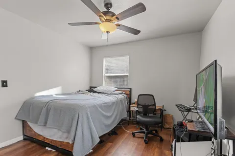 a bedroom with a bed and a chandelier