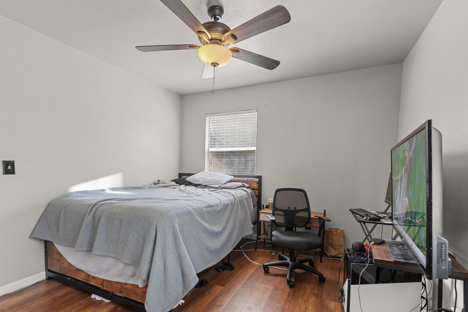 2123 15th Avenue Sacramento, CA 95822 - Photo 29 of 35 a bedroom with a bed and a chandelier