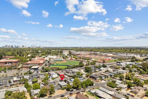 an aerial view of residential houses with city view