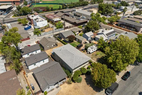 an aerial view of multiple houses with yard